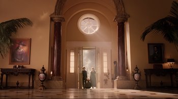 Movie still from “A Series of Unfortunate Events” (2004), directed by Brad Silberling – Two people standing in front of an open door; Extreme Wide shot, Low angle