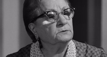 Movie still from “Lenny” (1974), directed by Bob Fosse – An older woman wearing glasses and a checkered shirt; Close Up shot, Low angle