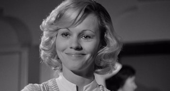 Movie still from “Lenny” (1974), directed by Bob Fosse – A black and white photo of a woman smiling for the camera; Close Up shot, Over the shoulder angle