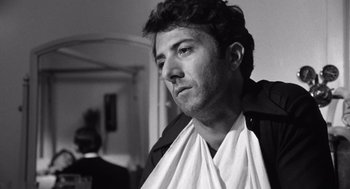 Movie still from “Lenny” (1974), directed by Bob Fosse – Black and white photograph of a man with a towel around his neck; Close Up shot, Low angle