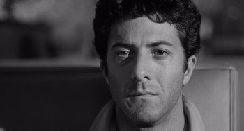 Movie still from “Lenny” (1974), directed by Bob Fosse – Black and white photograph of a young man looking at the camera; Close Up shot, Low angle