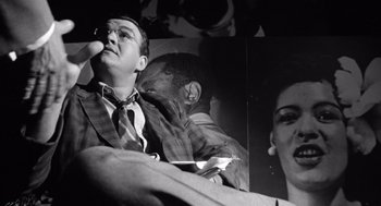 Movie still from “Lenny” (1974), directed by Bob Fosse – A black - and - white photo of a man and a woman; Close Up shot, Low angle