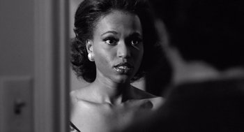Movie still from “Lenny” (1974), directed by Bob Fosse – A black and white photo of a woman looking into a mirror; Close Up shot, Over the shoulder angle