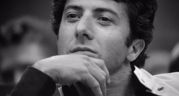 Movie still from “Lenny” (1974), directed by Bob Fosse – Black and white photograph of a man with his chin resting on his hands; Close Up shot, Low angle