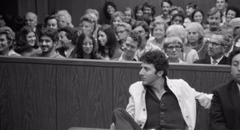 Movie still from “Lenny” (1974), directed by Bob Fosse – Black and white photograph of people in a courtroom; Medium shot, Over the shoulder angle