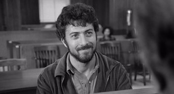 Movie still from “Lenny” (1974), directed by Bob Fosse – Black and white photograph of a man in a classroom; Close Up shot, Low angle