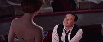 Movie still from “Les Girls” (1957), directed by George Cukor – A man and a woman in front of a mirror; Medium shot, Low angle