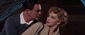 Movie still from “Les Girls” (1957), directed by George Cukor – A man and a woman are looking at one another; Close Up shot, Low angle