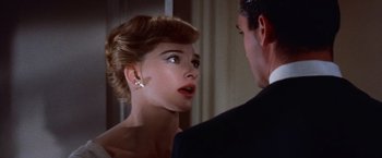 Movie still from “Les Girls” (1957), directed by George Cukor – A man and a woman are talking to each other; Close Up shot, Over the shoulder angle
