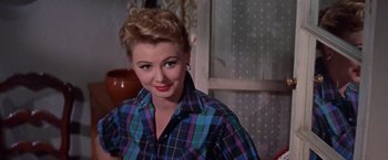 Movie still from “Les Girls” (1957), directed by George Cukor – A person wearing a plaid shirt; Close Up shot, Over the shoulder angle