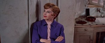 Movie still from “Les Girls” (1957), directed by George Cukor – A woman in a purple jacket and a pink tie; Close Up shot, Low angle