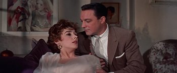 Movie still from “Les Girls” (1957), directed by George Cukor – A man and a woman are sitting together; Close Up shot, Low angle