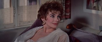 Movie still from “Les Girls” (1957), directed by George Cukor – A person wearing a white shirt; Close Up shot, Over the shoulder angle
