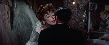 Movie still from “Les Girls” (1957), directed by George Cukor – A woman in a white dress and a man in a black suit; Close Up shot, Over the shoulder angle