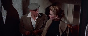 Movie still from “Les Girls” (1957), directed by George Cukor – A man and a woman are talking to each other; Medium shot, Low angle