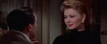 Movie still from “Les Girls” (1957), directed by George Cukor – A man and a woman talking in a room; Close Up shot, Over the shoulder angle