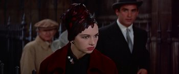 Movie still from “Les Girls” (1957), directed by George Cukor – A person wearing a hat; Close Up shot, Over the shoulder angle