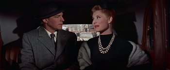 Movie still from “Les Girls” (1957), directed by George Cukor – A man and a woman sitting in the back of a car; Close Up shot, Over the shoulder angle