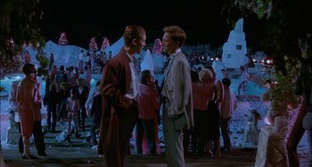 Movie still from “Less Than Zero” (1987), directed by Marek Kanievska – Two men talking to each other at a party; Wide shot, Over the shoulder angle