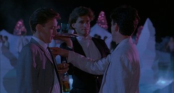 Movie still from “Less Than Zero” (1987), directed by Marek Kanievska – A group of young men standing next to each other; Medium shot, Over the shoulder angle