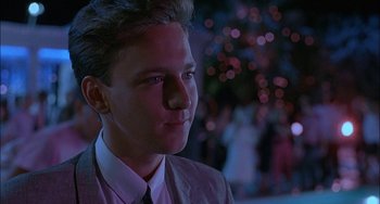 Movie still from “Less Than Zero” (1987), directed by Marek Kanievska – A man in a suit and tie looking to his left; Close Up shot, Low angle