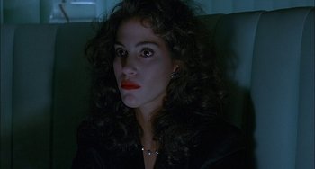 Movie still from “Less Than Zero” (1987), directed by Marek Kanievska – A person with curly hair wearing a jacket; Close Up shot, High angle