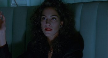 Movie still from “Less Than Zero” (1987), directed by Marek Kanievska – A person sitting in a chair; Close Up shot, Low angle