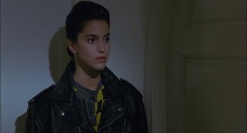 Movie still from “Less Than Zero” (1987), directed by Marek Kanievska – A woman wearing a leather jacket looking to her left; Close Up shot, Over the shoulder angle