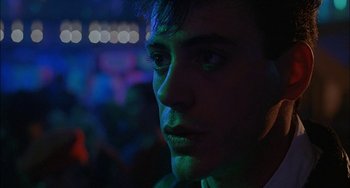 Movie still from “Less Than Zero” (1987), directed by Marek Kanievska – A man's face at a party; Close Up shot, Low angle