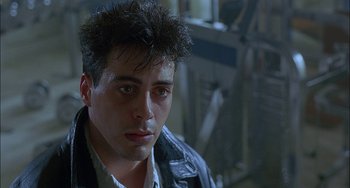 Movie still from “Less Than Zero” (1987), directed by Marek Kanievska – A person wearing a leather jacket; Close Up shot, Low angle