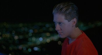 Movie still from “Less Than Zero” (1987), directed by Marek Kanievska – A young man is looking into the distance at night; Close Up shot, Low angle