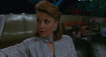 Movie still from “Less Than Zero” (1987), directed by Marek Kanievska – A person wearing a dress; Close Up shot, Over the shoulder angle