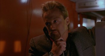 Movie still from “Less Than Zero” (1987), directed by Marek Kanievska – A person holding a cell phone to his ear; Close Up shot, Low angle