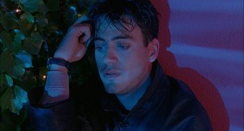 Movie still from “Less Than Zero” (1987), directed by Marek Kanievska – A person wearing a black jacket; Close Up shot, High angle
