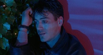 Movie still from “Less Than Zero” (1987), directed by Marek Kanievska – A person wearing a black jacket; Close Up shot, High angle