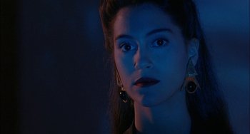Movie still from “Less Than Zero” (1987), directed by Marek Kanievska – A young woman with blue eye shadow and black lipstick; Close Up shot, Over the shoulder angle