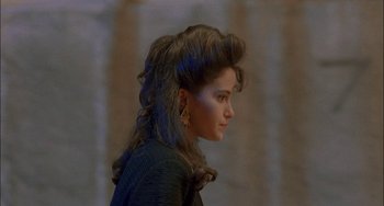 Movie still from “Less Than Zero” (1987), directed by Marek Kanievska – A young woman with long hair and a ponytail; Close Up shot, Over the shoulder angle