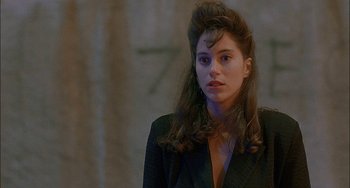 Movie still from “Less Than Zero” (1987), directed by Marek Kanievska – A young woman with long dark hair wearing a black jacket; Close Up shot, Over the shoulder angle