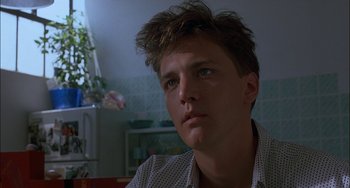 Movie still from “Less Than Zero” (1987), directed by Marek Kanievska – A young man is looking into the distance; Close Up shot, Low angle