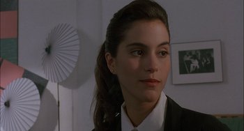 Movie still from “Less Than Zero” (1987), directed by Marek Kanievska – A person wearing a suit and tie; Close Up shot, Over the shoulder angle