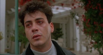 Movie still from “Less Than Zero” (1987), directed by Marek Kanievska – A person wearing a leather jacket; Close Up shot, Low angle