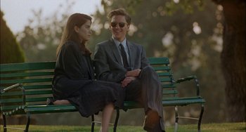 Movie still from “Less Than Zero” (1987), directed by Marek Kanievska – A man and a woman sitting on a park bench; Medium shot, Over the shoulder angle