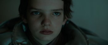Movie still from “Let Me In” (2010), directed by Matt Reeves – A person's face with blue eyes; Close Up shot, Low angle
