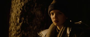 Movie still from “Let Me In” (2010), directed by Matt Reeves – A young woman wearing a hat and a scarf; Close Up shot, Over the shoulder angle