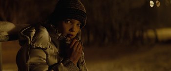 Movie still from “Let Me In” (2010), directed by Matt Reeves – A young person wearing a jacket and a hat; Close Up shot, Low angle