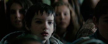 Movie still from “Let Me In” (2010), directed by Matt Reeves – A young boy and a woman are looking at the camera; Close Up shot, Over the shoulder angle
