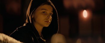Movie still from “Let Me In” (2010), directed by Matt Reeves – A young man wearing a hooded sweatshirt looks into the camera; Close Up shot, Low angle