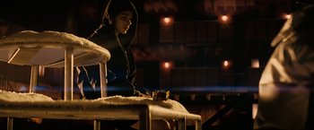 Movie still from “Let Me In” (2010), directed by Matt Reeves – A person sitting on top of a chair in a room; Medium shot, Over the shoulder angle