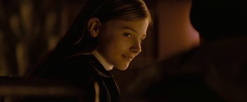 Movie still from “Let Me In” (2010), directed by Matt Reeves – A young girl is looking into the distance; Close Up shot, Over the shoulder angle