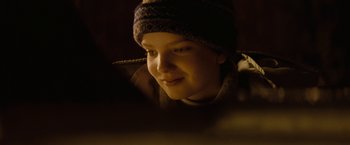 Movie still from “Let Me In” (2010), directed by Matt Reeves – A woman wearing a hat looking at the camera; Close Up shot, Over the shoulder angle